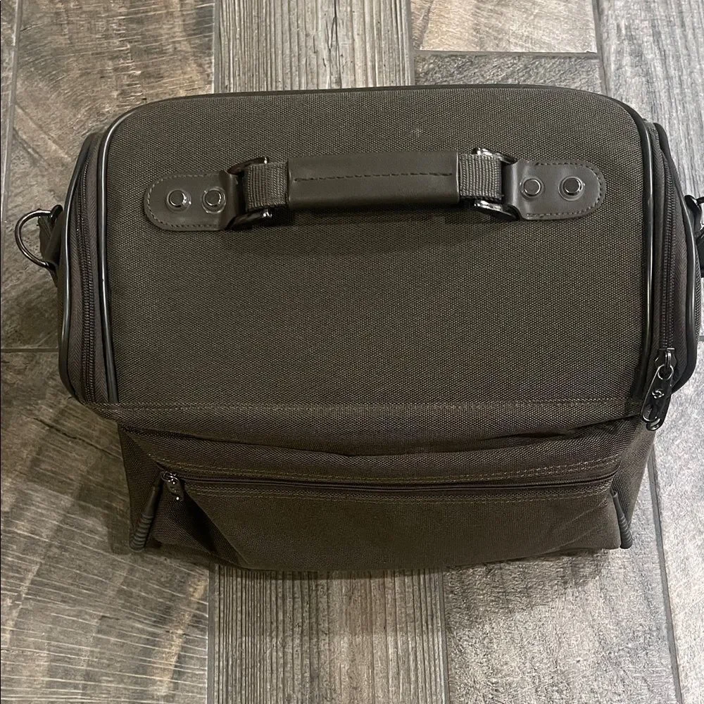 Samsonite army green Bag fits on luggage. 15”x 12”x 19” adjustable strap